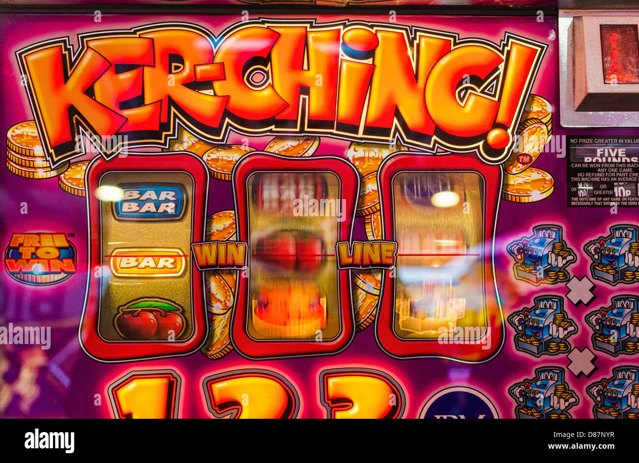 Fruit machine spinning reels in an amusement arcade, UK Stock Photo