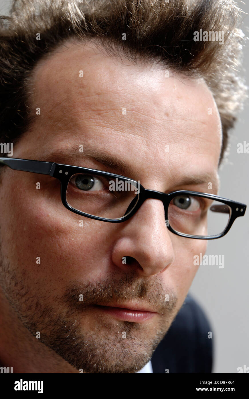 Man, 40, with glasses and unshaved Stock Photo
