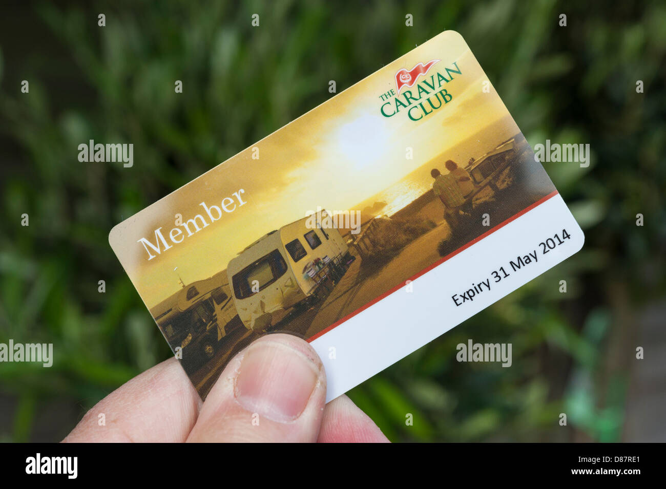 A UK Caravan Club membership card being held in a hand with a blurred