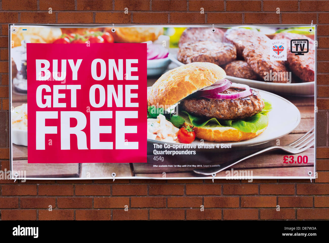 Buy one get one free food deal for cheap burgers on a poster on a co-op supermarket store front, UK Stock Photo