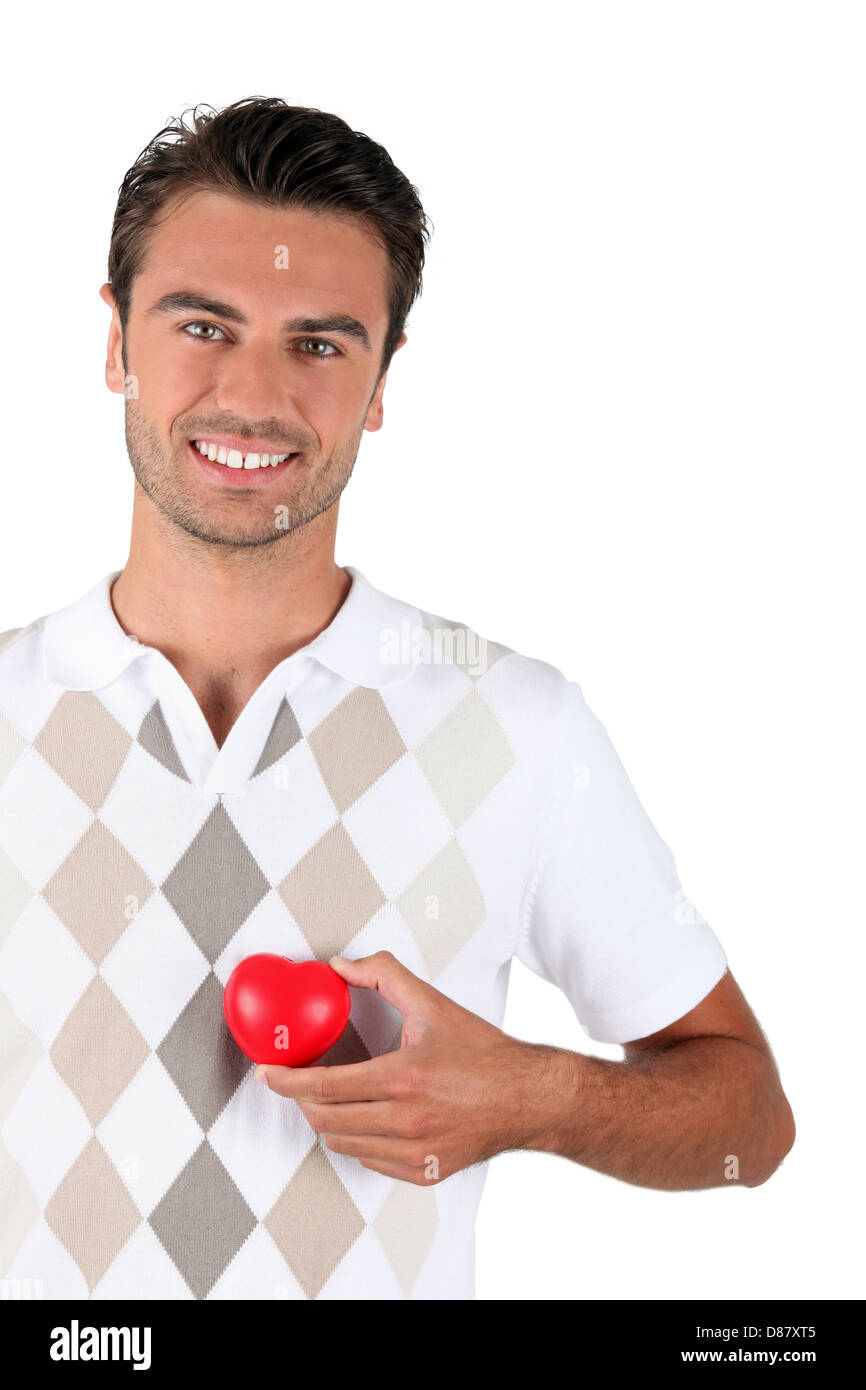 Young man holding red heart Stock Photo - Alamy