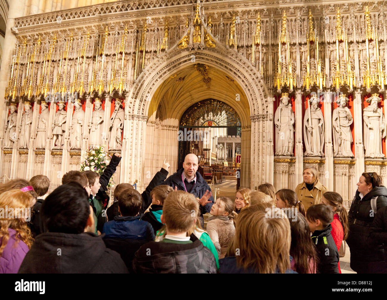 Children and their teacher on school trip guided tour of York Minster