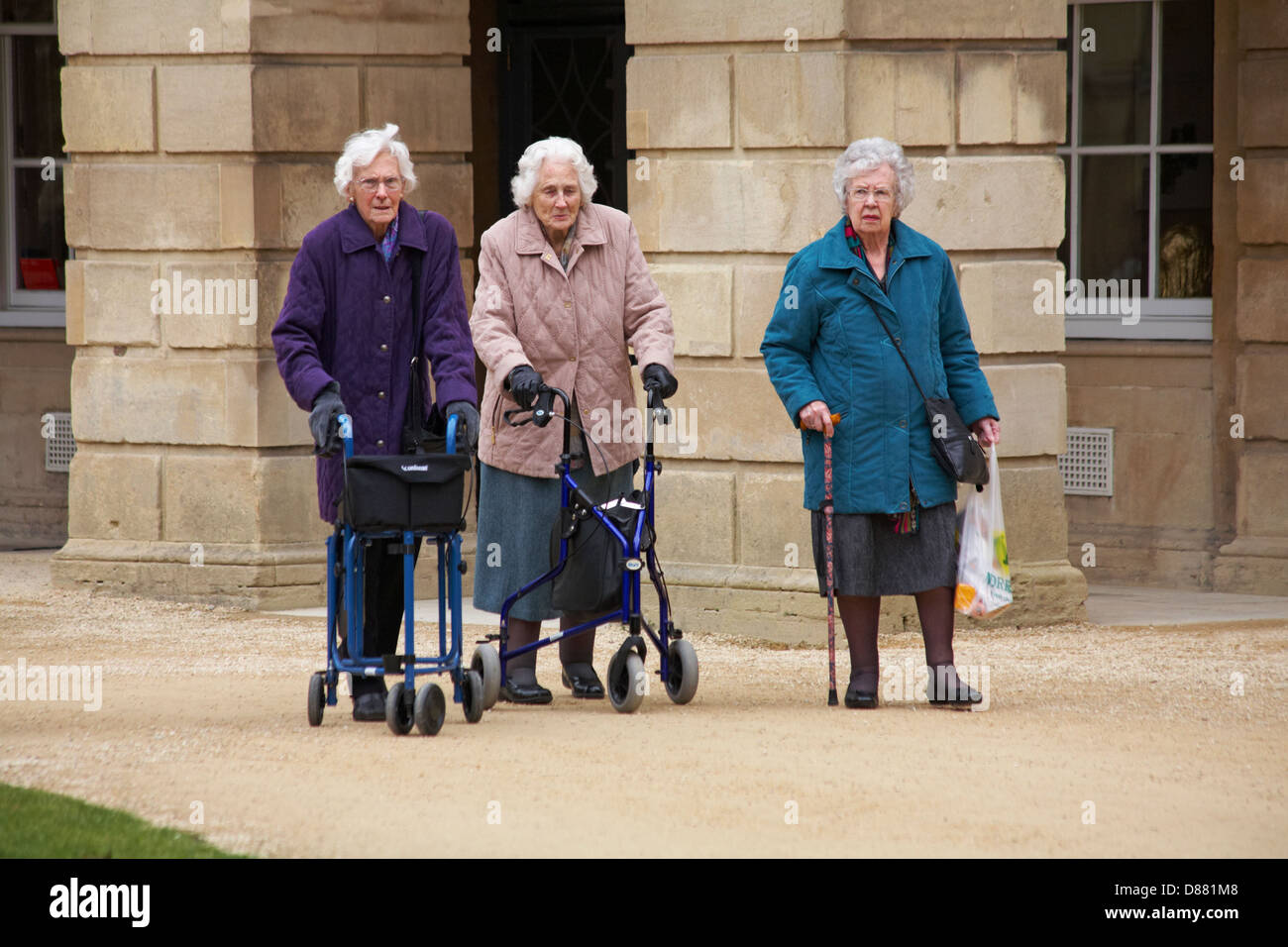 3 female pensioners with walking aids in the grounds of Holburne Museum in Sydney Pleasure Gardens at Great Pulteney St, Bathwick, Bath, Somerset UK Stock Photo