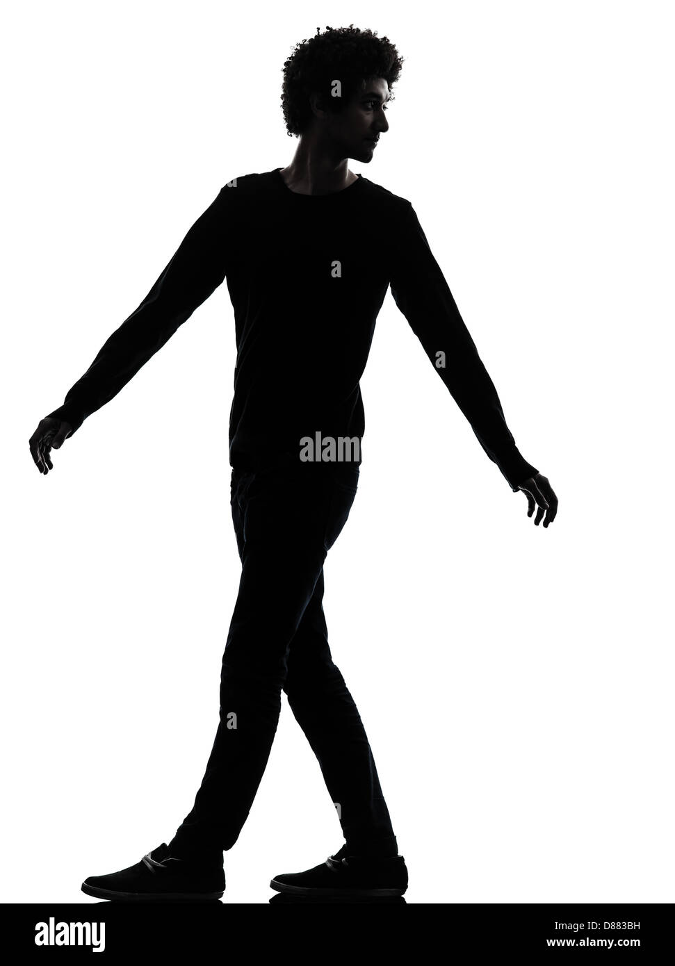 one african handsome young man looking back in silhouette studio isolated on white background Stock Photo