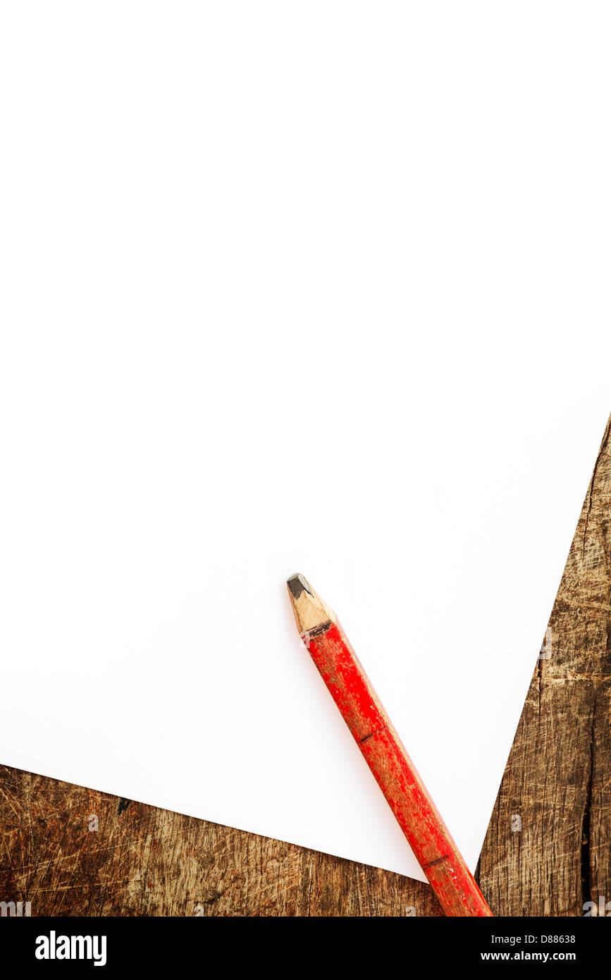 Old lead pencil and white blank paper on wood background. Stock Photo