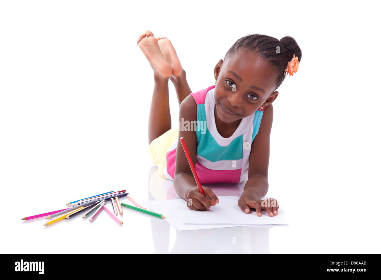 Cute black african american little girl drawing, isolated on white background - African people - Children Stock Photo