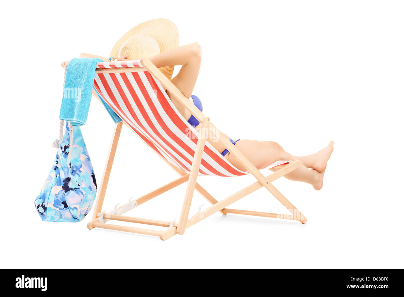 Young female in bikini lying on a beach chair isolated on white