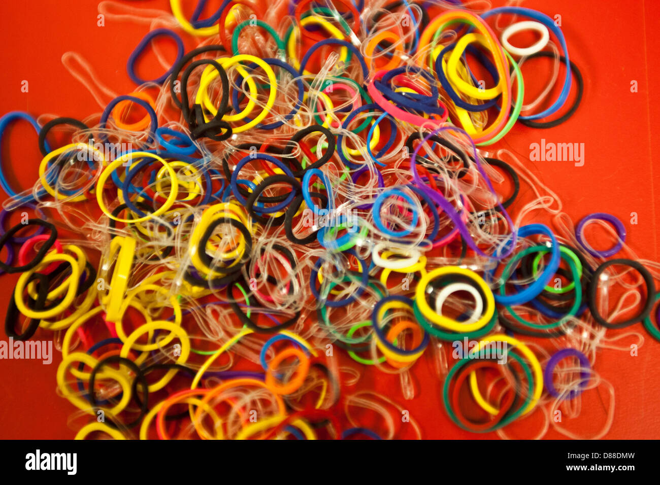 Rubber Bands on Red Background Stock Photo Alamy