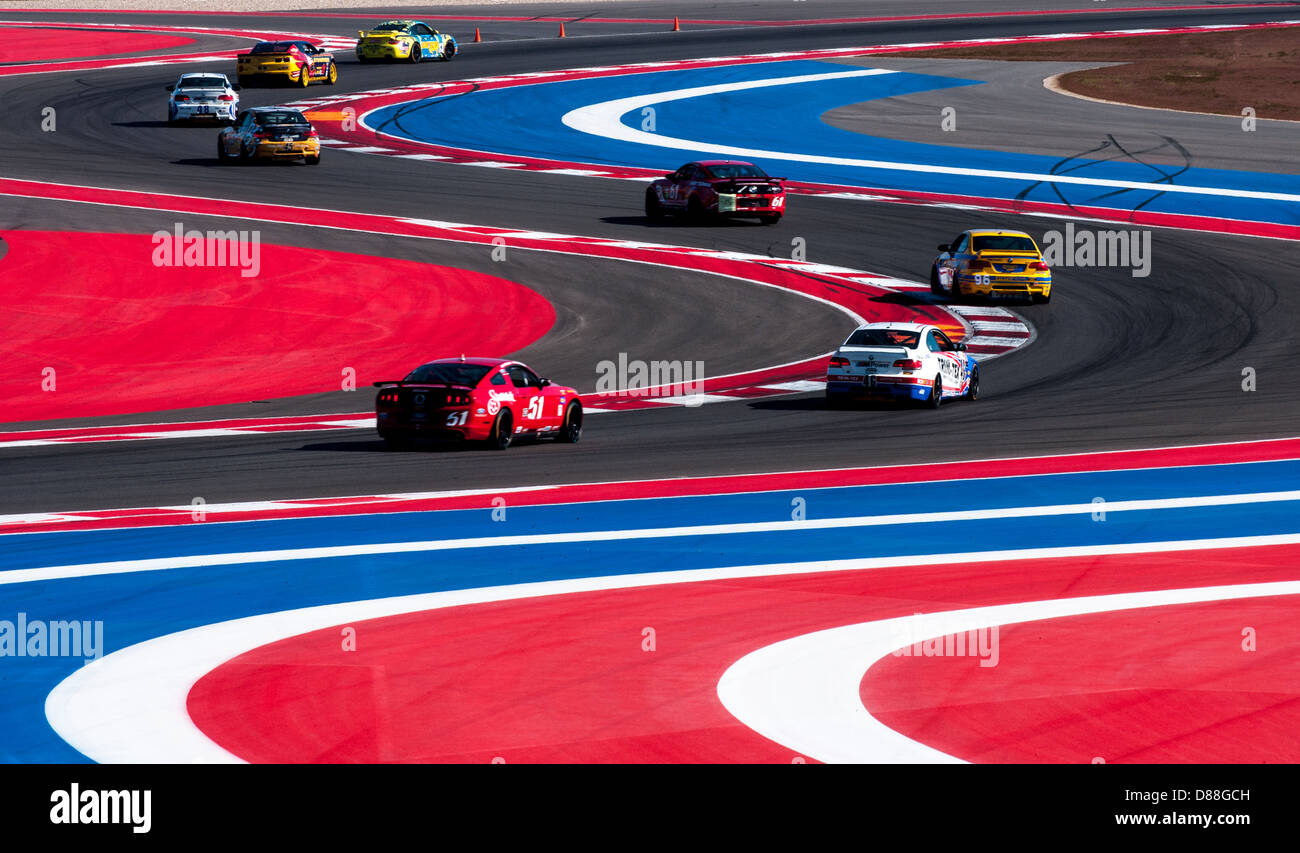 Several racing cars negotiate the S-curves at Circuit of the Americas, Austin, Texas during Grand-Am racing weekend, 2013 Stock Photo
