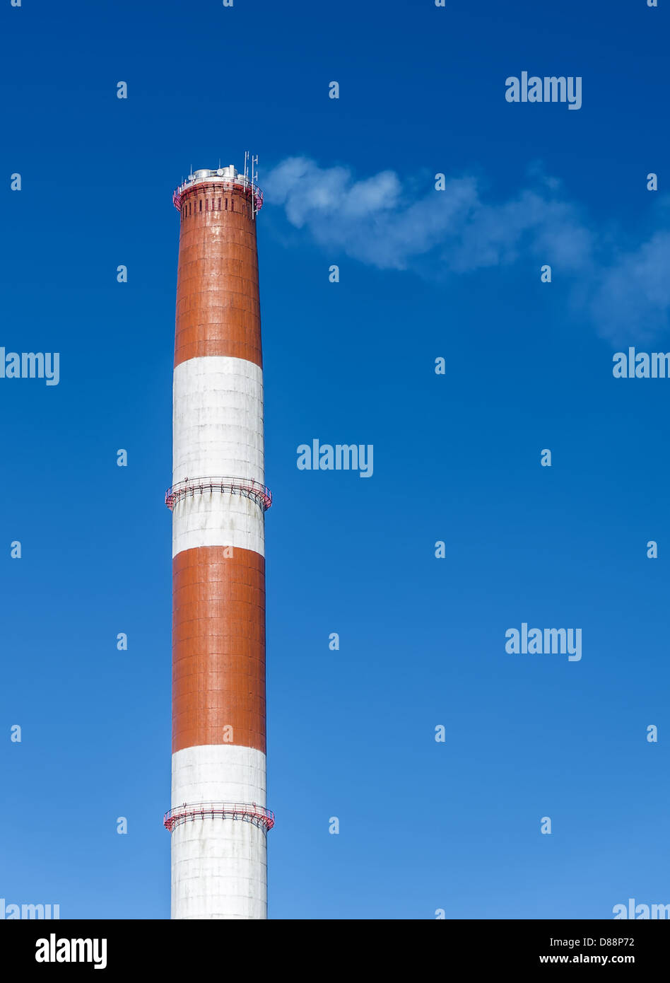 Industrial chimney with smoke over blue sky Stock Photo - Alamy