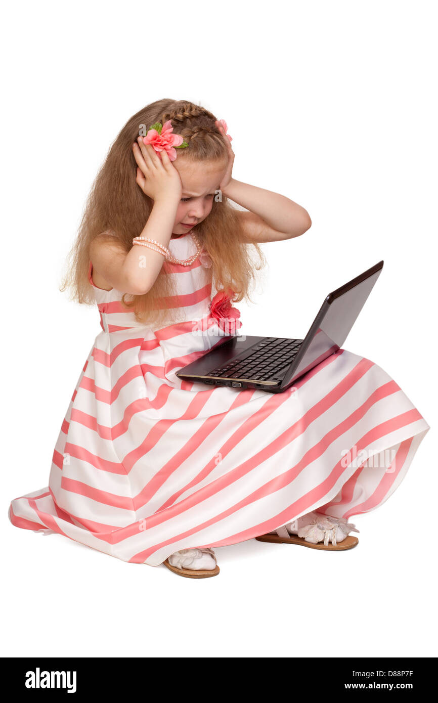 Adorable little girl stressed by laptop isolated on white background Stock Photo
