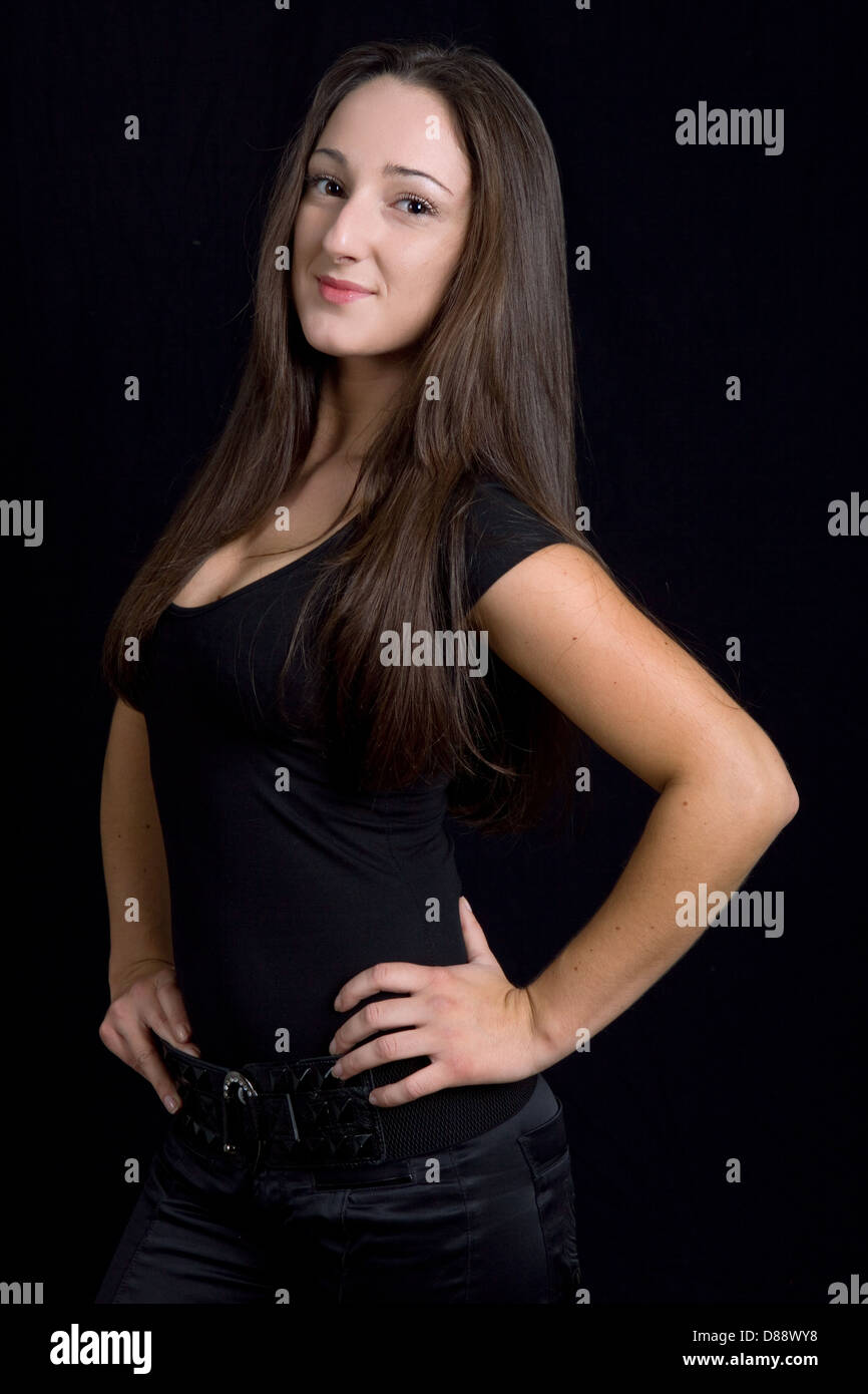 young beautiful brunette portrait against black background Stock Photo ...