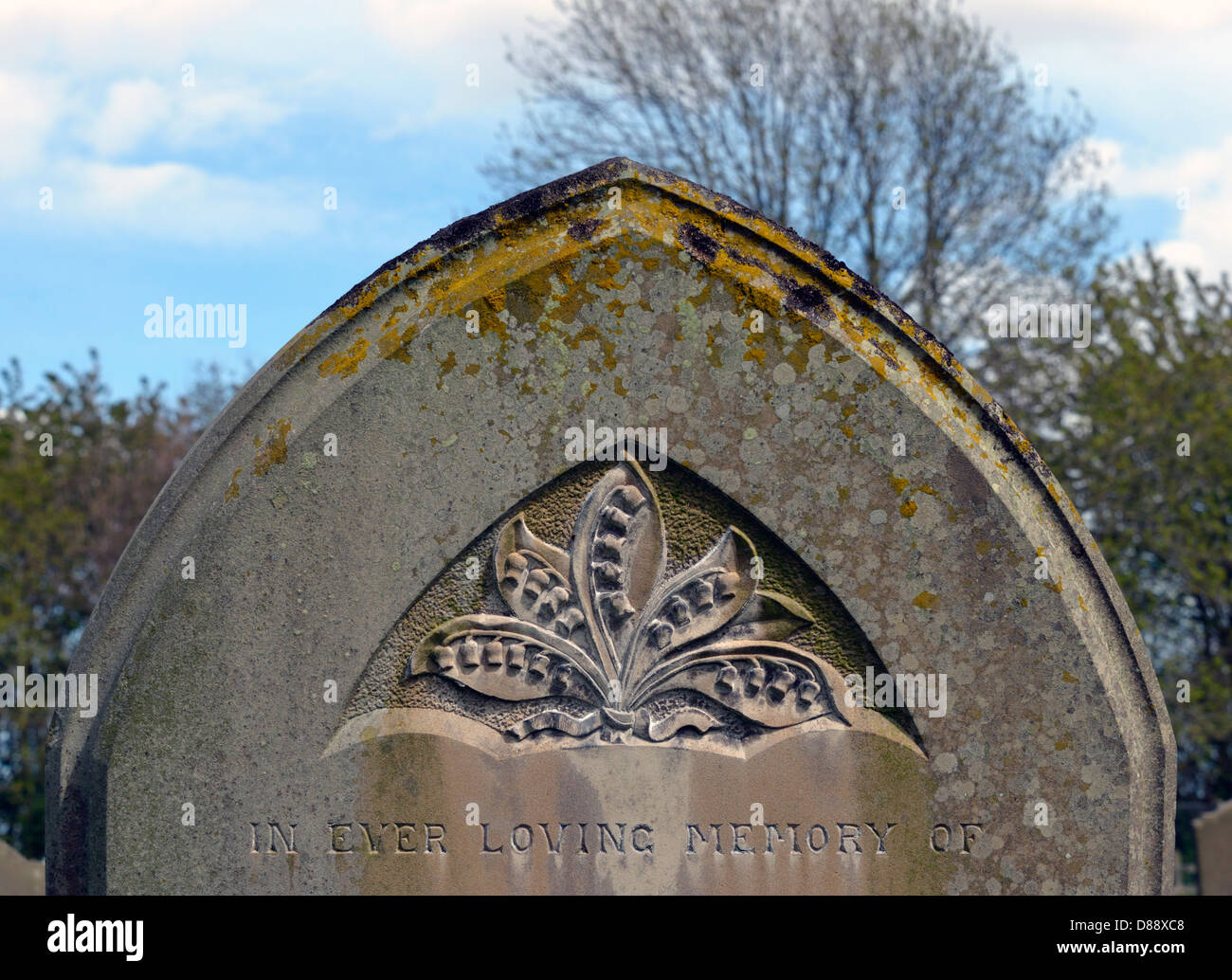 Gravestone with lilies design. Church of All Saints. Frostenden, Suffolk, England, United Kingdom, Europe. Stock Photo