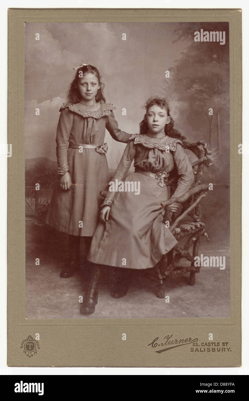 Original cabinet card photograph portrait of two pretty young Victorian or Edwardian era girls, probably sisters - circa 1901 Salisbury, Wiltshire, England, U.K. Stock Photo