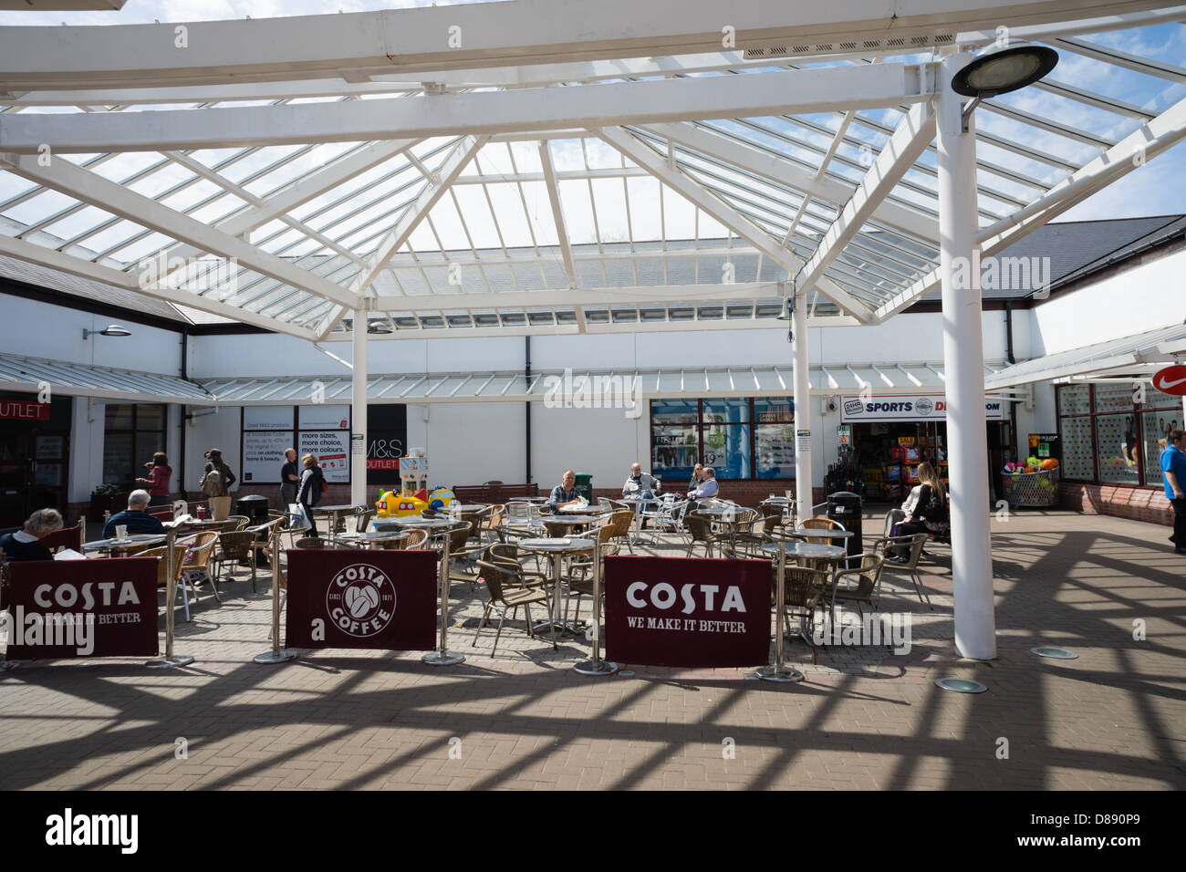 Gretna Outlet Village, open air mall at Gretna Green in Scotland. Glass roofed outdoor seating