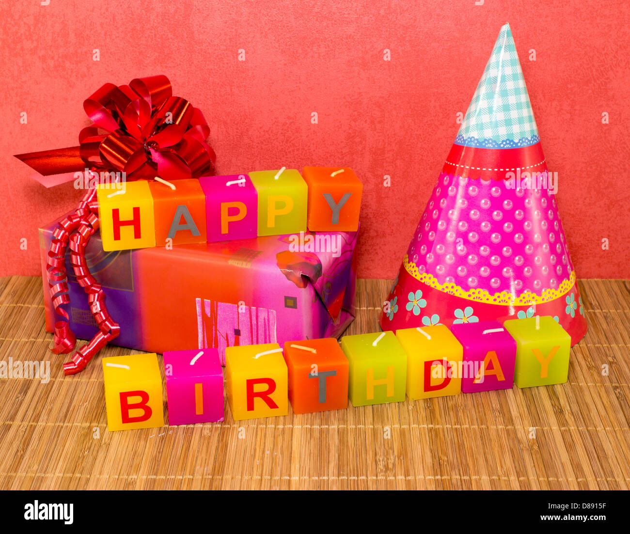happy birthday candles with present and red wallpaper Stock Photo Alamy