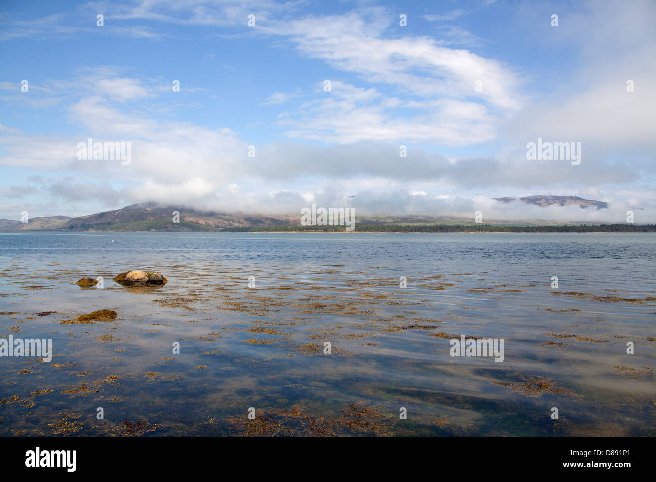 Loch Fleet, Scotland. Loch Fleet with a cloud covered Balblair Wood, Mound Rock and Silver Rock in the background. Stock Photo