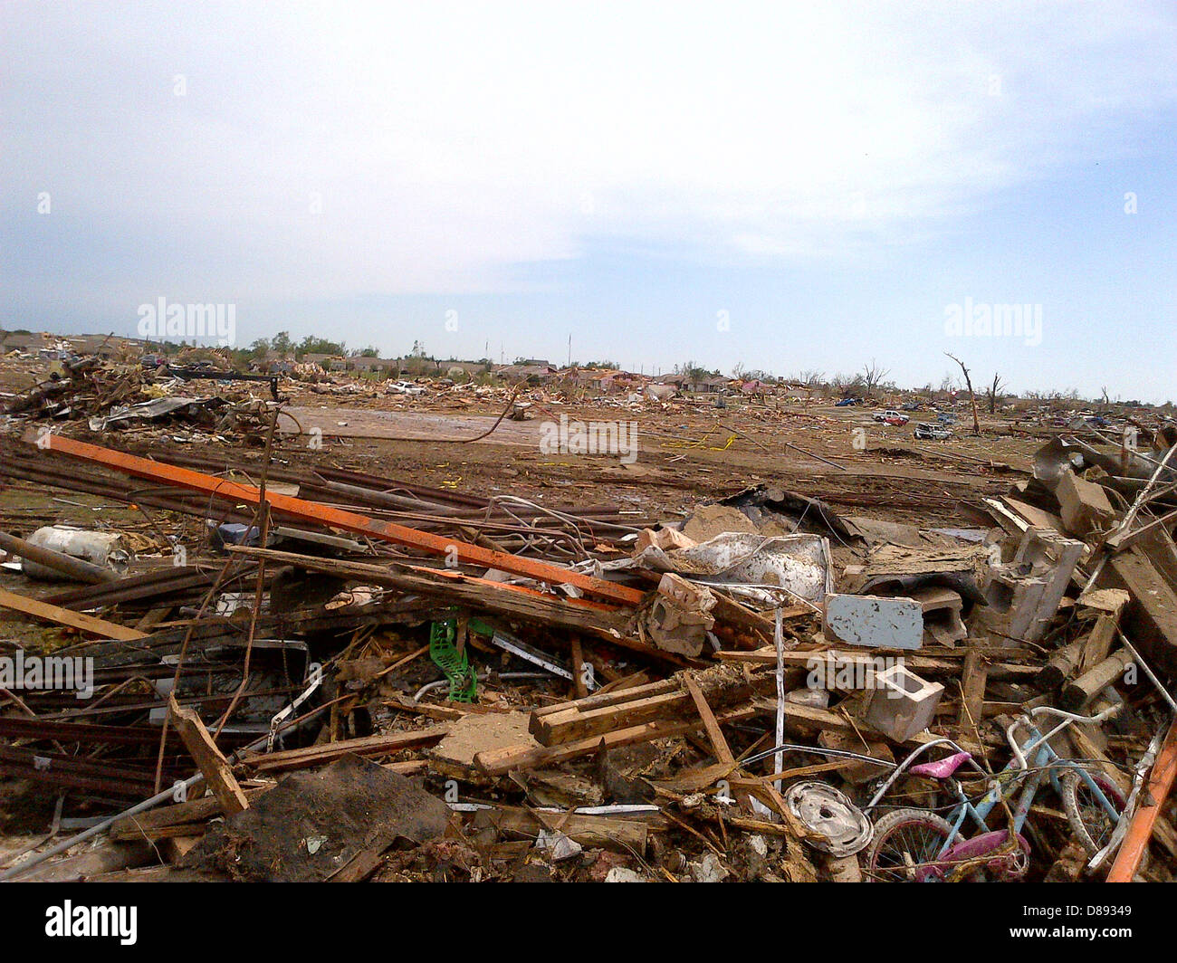Aftermath of destroyed homes leveled by an EF-5 tornado May 21, 2013 in Moore, Oklahoma. The massive storm with winds exceeding 200 miles per hour tore through the Oklahoma City suburb May 20, 2013, killing at least 24 people, injuring more than 230 and displacing thousands. Stock Photo
