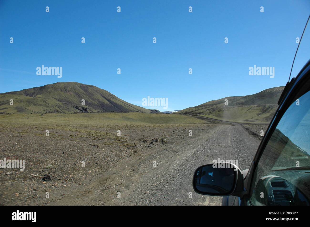On a dirt track  in a 4x4 to the way to Landmannalaugar in Iceland. A plume of dust can be seen from the car ahead. Stock Photo
