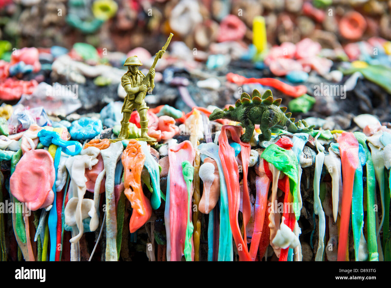Gum Wall with a wwi soldier figurine fighting off a dinosaur Stock Photo
