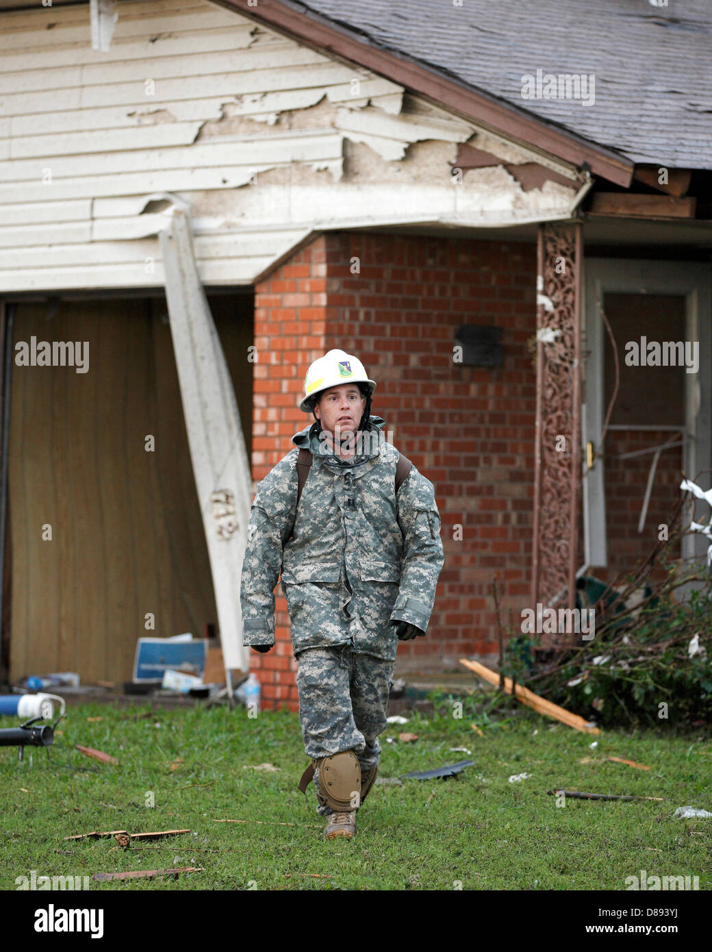 Soldiers with the Oklahoma National Guard conducts search and rescue operations in the aftermath of an EF-5 tornado that destroyed the town May 21, 2013 in Moore, Oklahoma. The massive storm with winds exceeding 200 miles per hour tore through the Oklahoma City suburb May 20, 2013, killing at least 24 people, injuring more than 230 and displacing thousands. Stock Photo