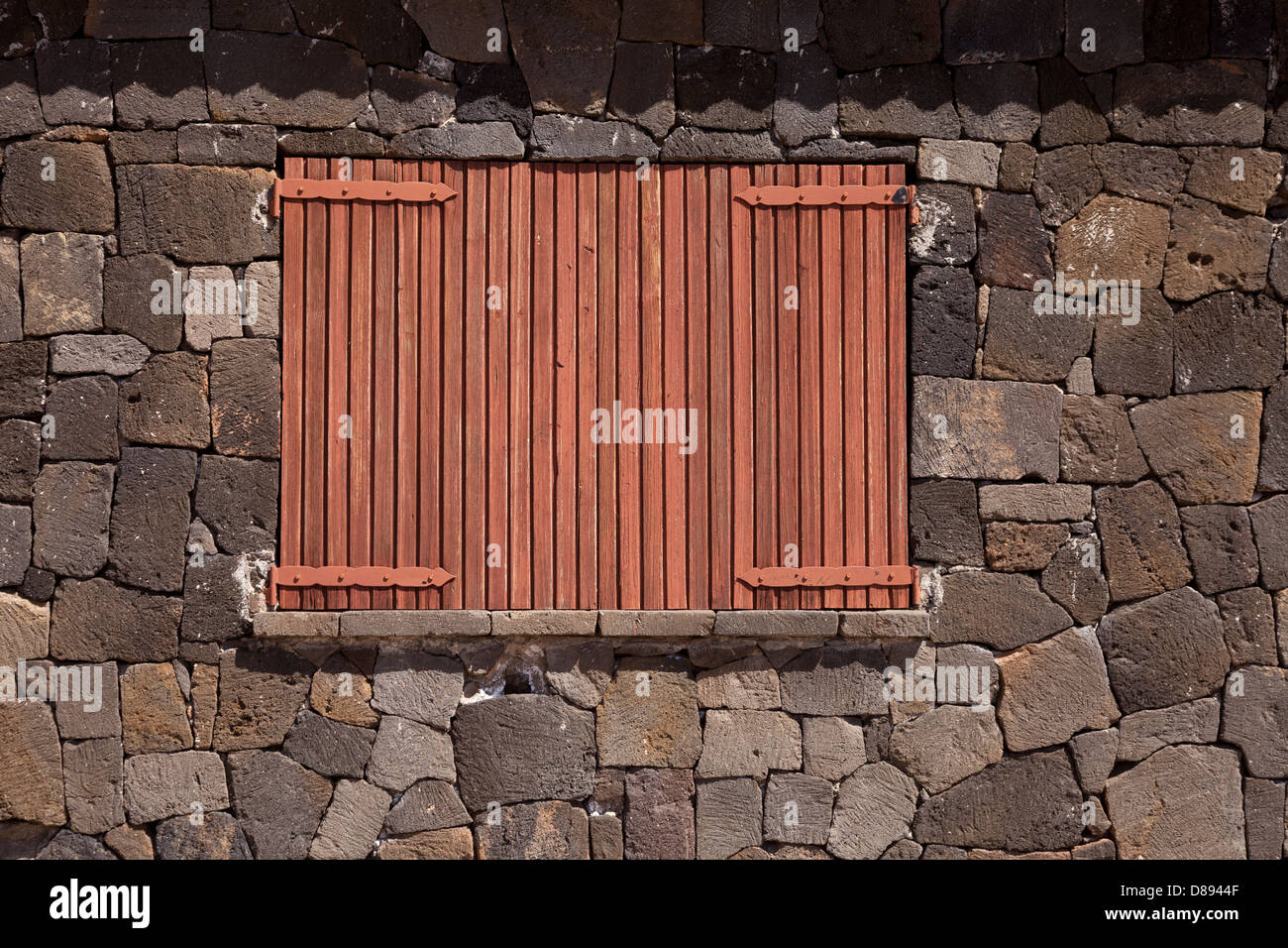 Wooden window shutter closed with natural stone wall Stock Photo - Alamy