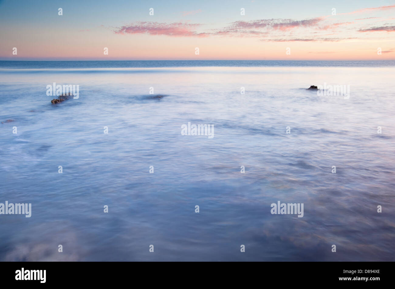 Stunning Summer sunset over ocean with rocks and vibrant colors Stock ...
