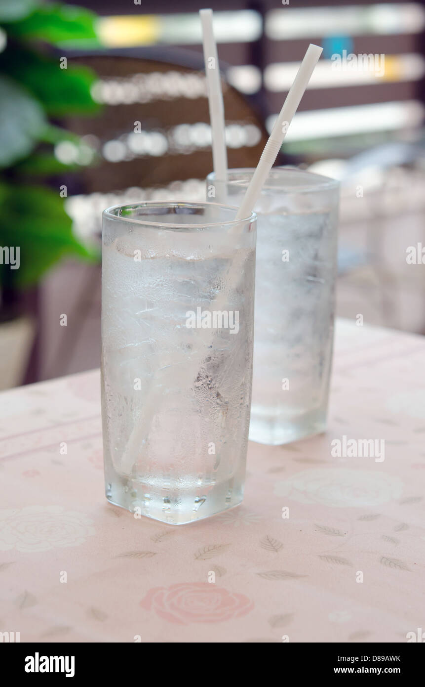 two glass of water with ice on table in restaurant Stock Photo