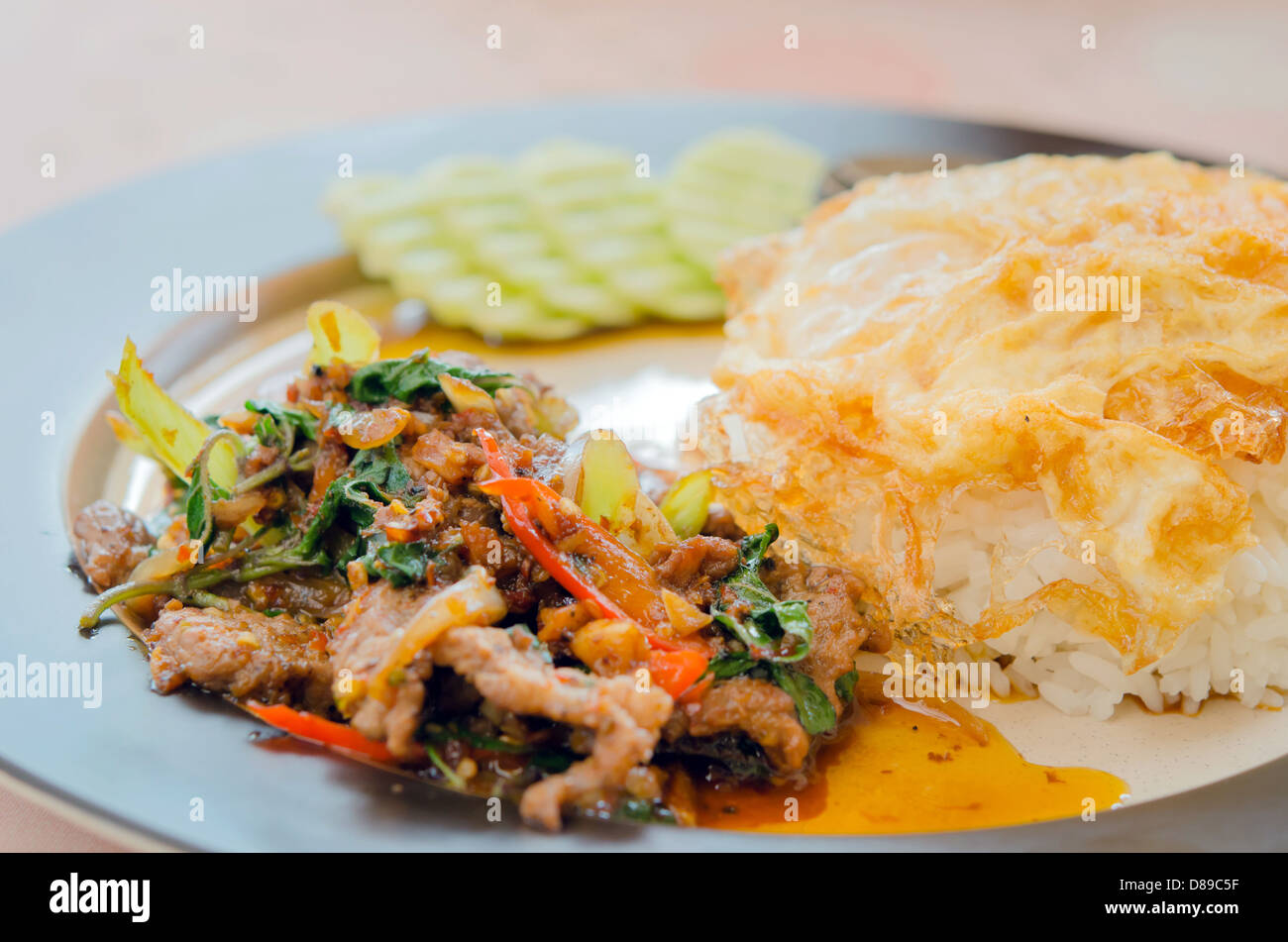 fried egg over rice and pork fried with chili pepper , sweet basil ...