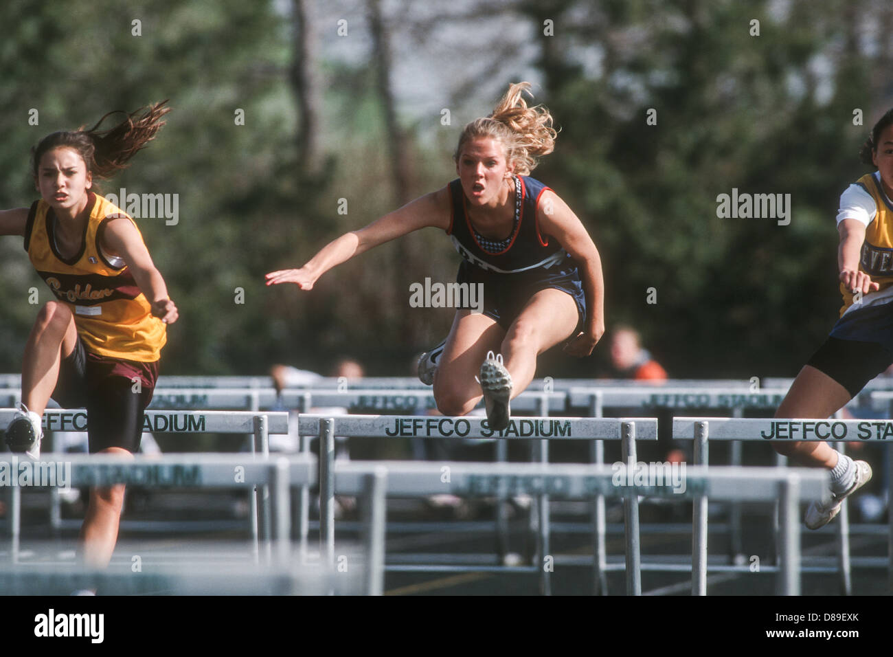 High School girl competing in track and field hurdles Stock Photo Alamy