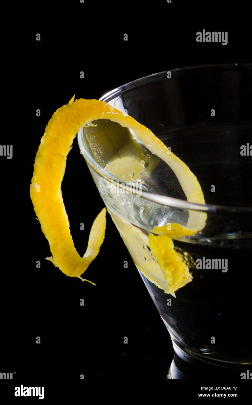 stemless martini with a lemon twist served on a dark background Stock