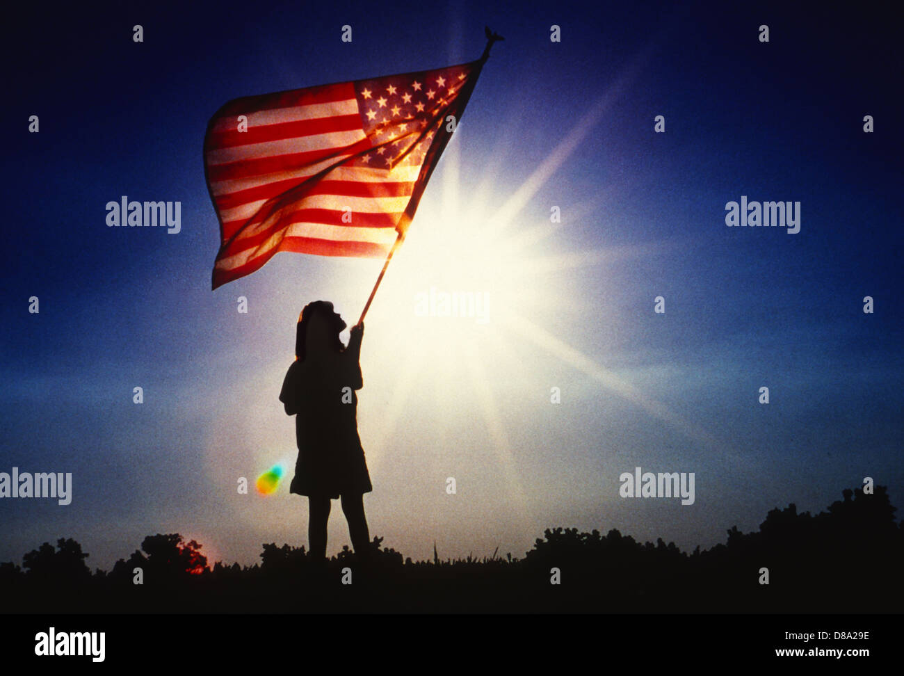 Girl holding American flag at sunrise Stock Photo - Alamy