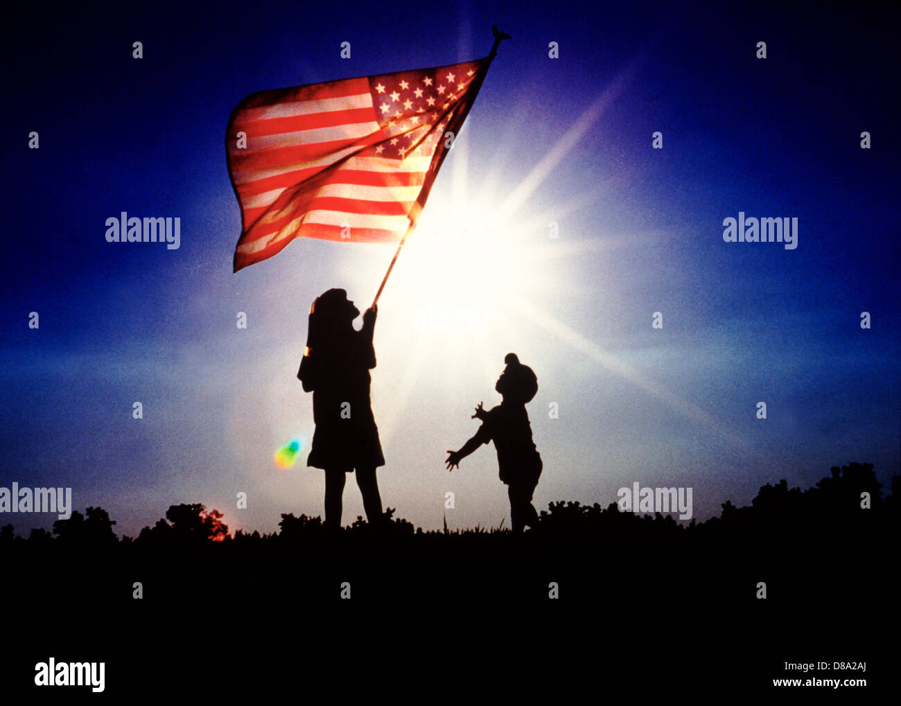 Boy and girl holding American flag at sunrise Stock Photo - Alamy