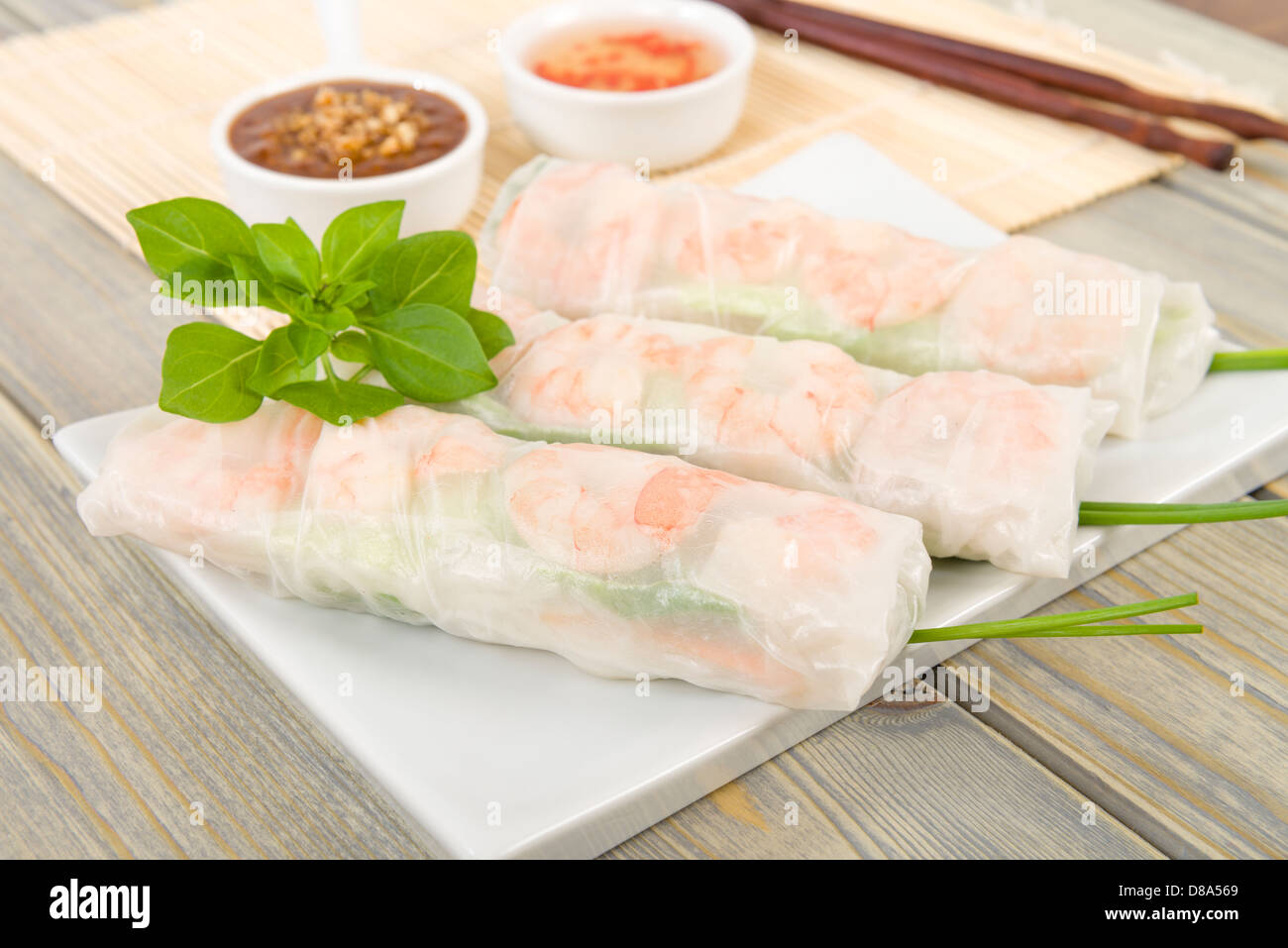 Goi Cuon - Vietnamese fresh summer rolls filled with prawns, pork, herbs, rice vermicelli and vegetables. Stock Photo