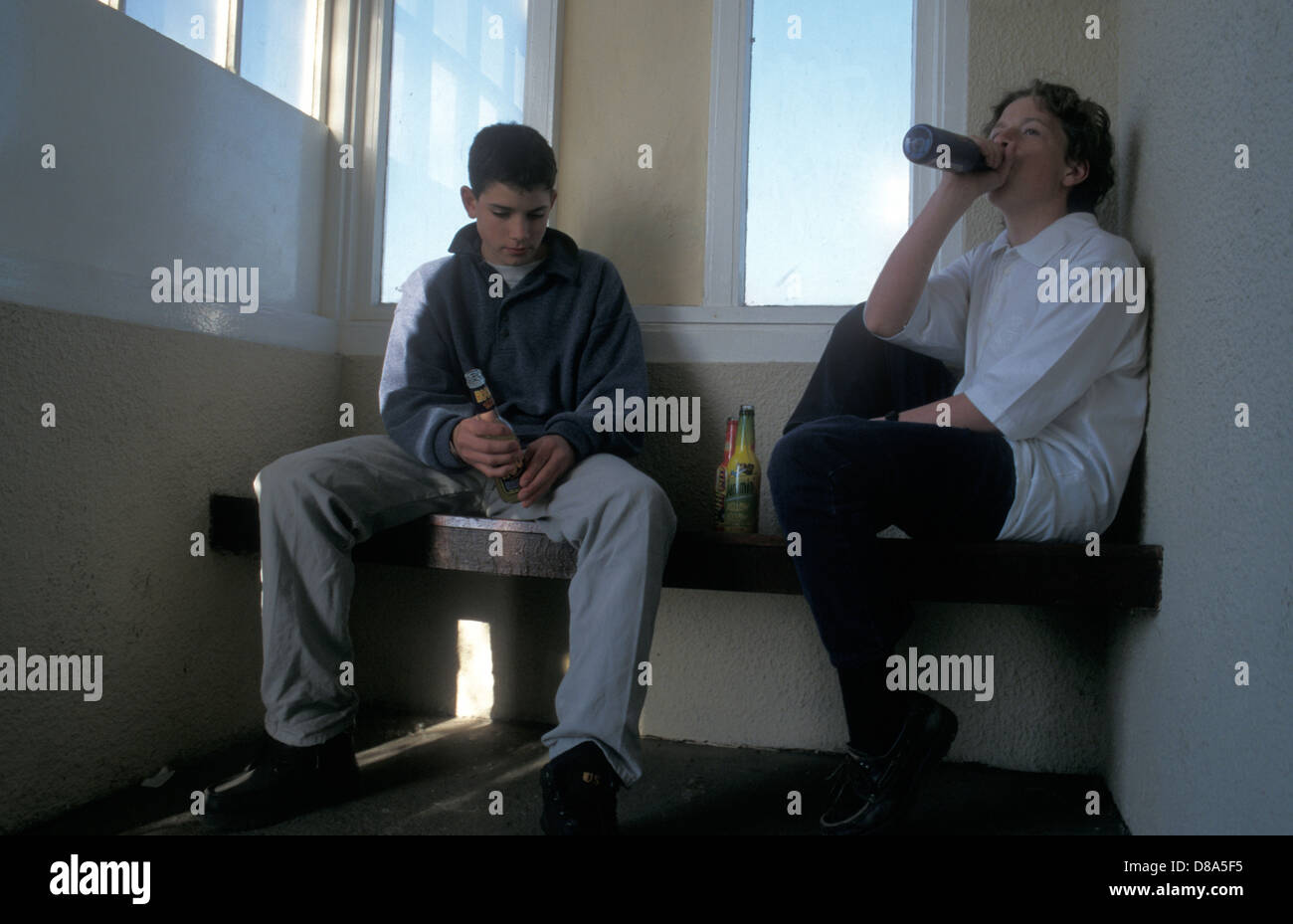 Two Young Boys Drinking Alcohol In Bus Shelter Stock Photo Alamy