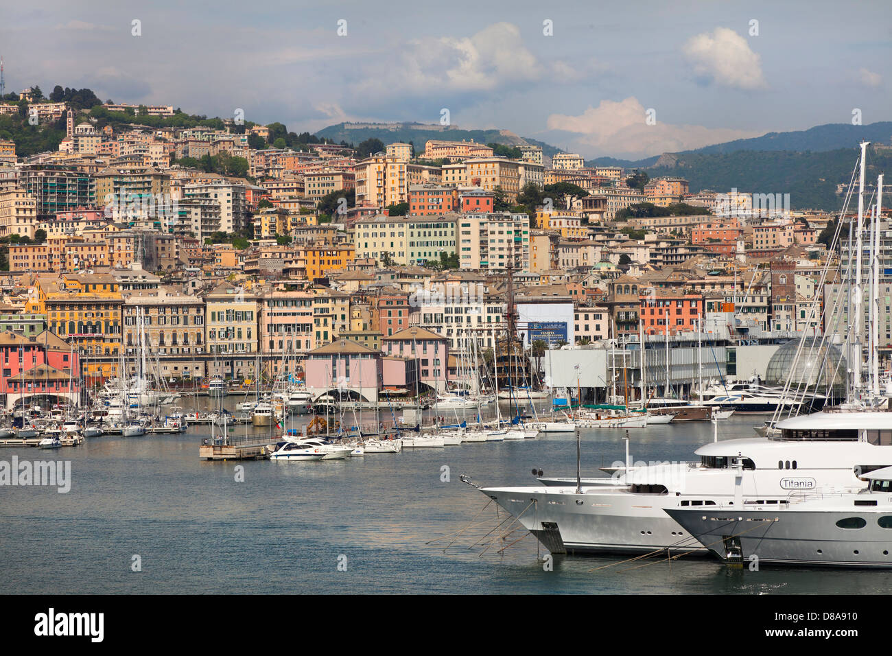 Genoa port, Italy, dockside view looking inland, typical Genoa houses. Private yachts in foreground. Stock Photo