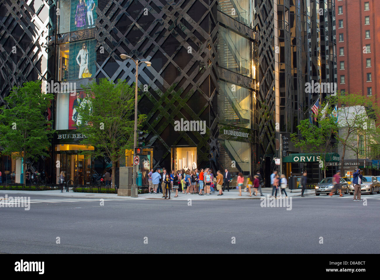 shoppers at the base of the burberry store building in downtown chicago on michigan avenue during spring season shoppers Stock Photo