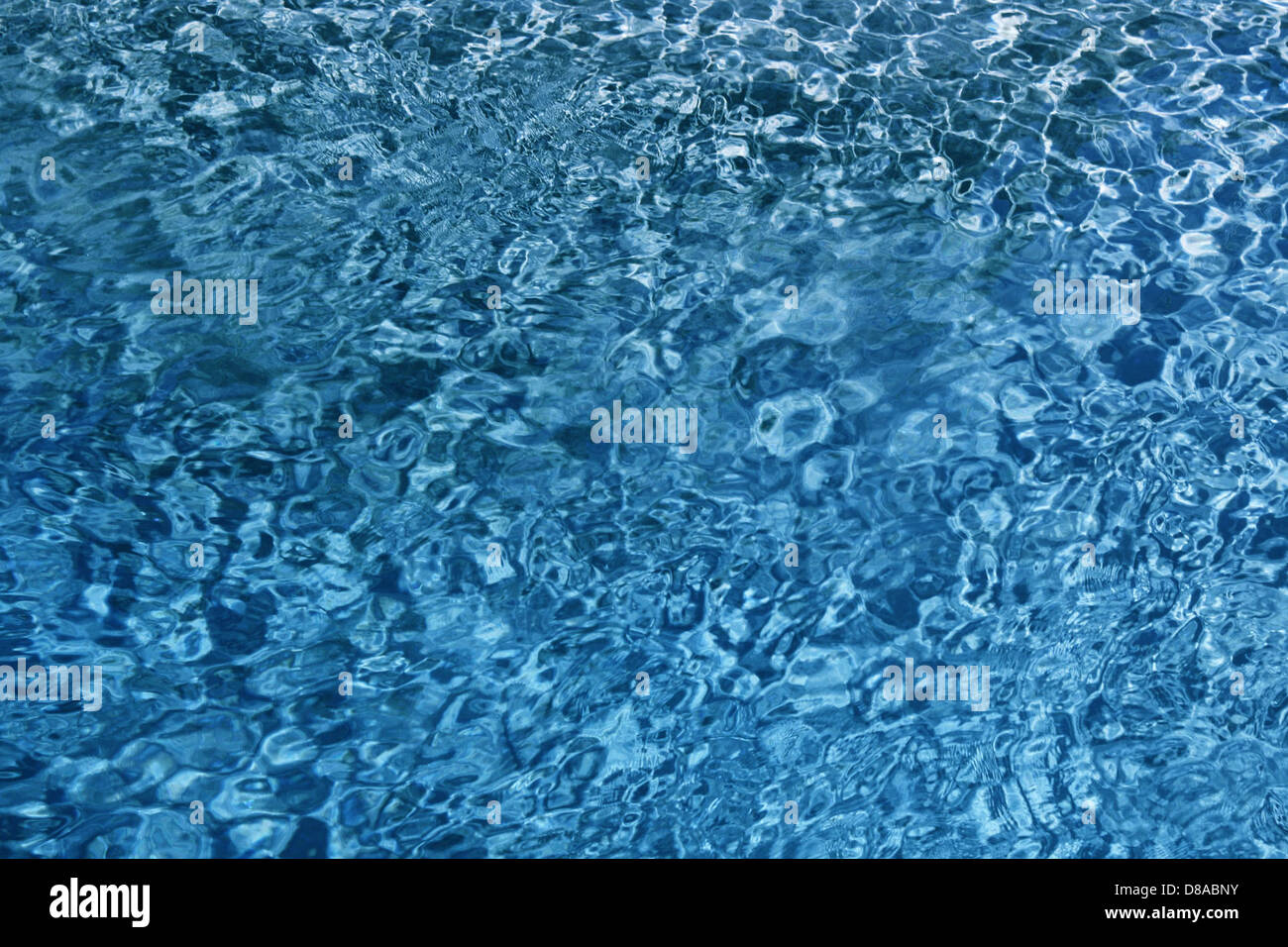 A close-up of blue water with visible ripples on the surface. The image ...