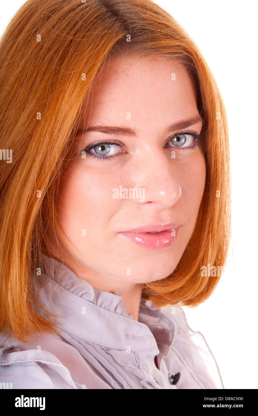 Portrait of smiling red-haired beautiful looking at a camera young ...
