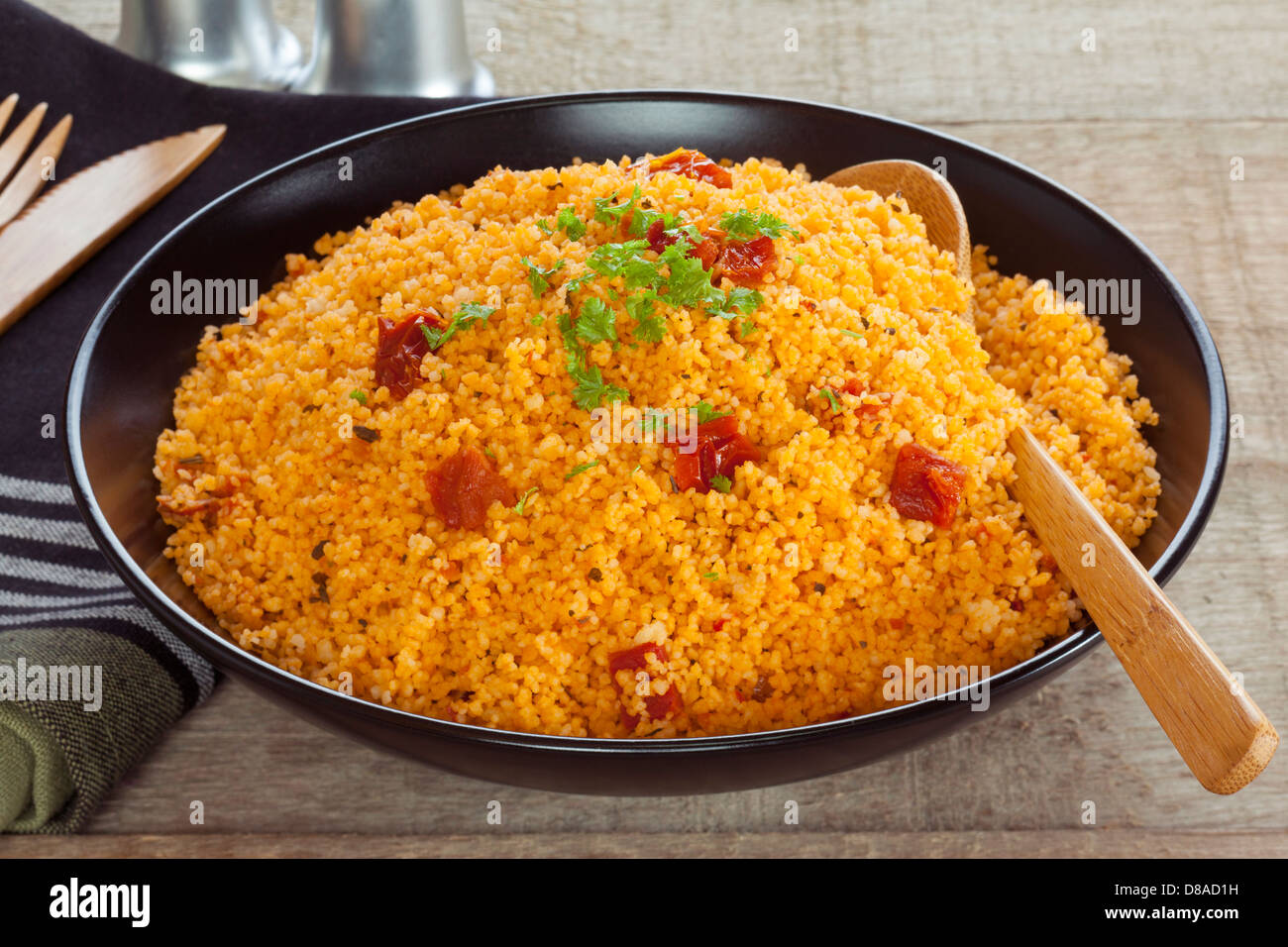 Couscous with Tomato - a bowl of couscous flavoured with sun dried tomato pesto. Stock Photo