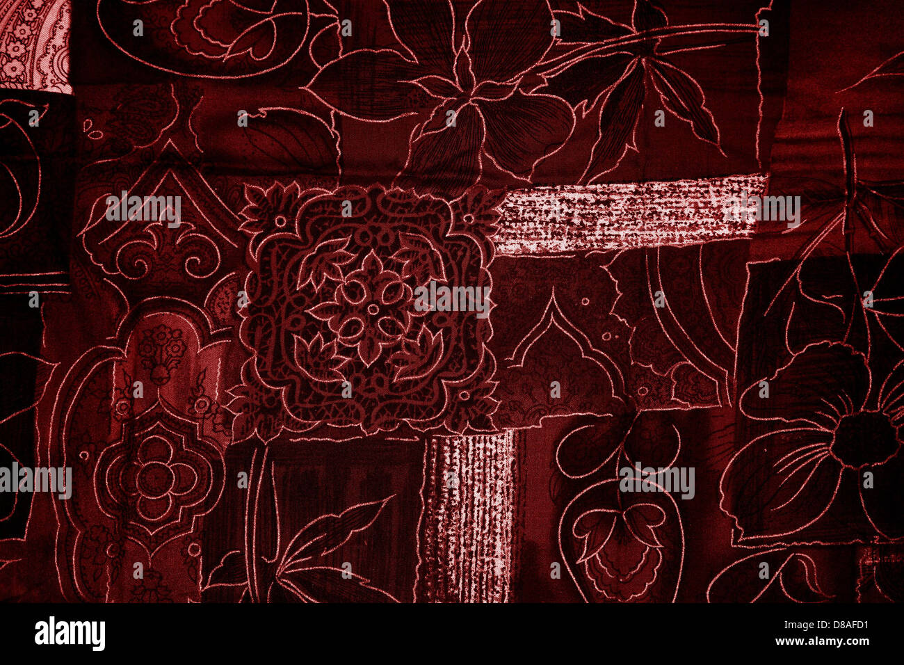 A close-up of maroon patchwork fabric, showcasing the intricate ...