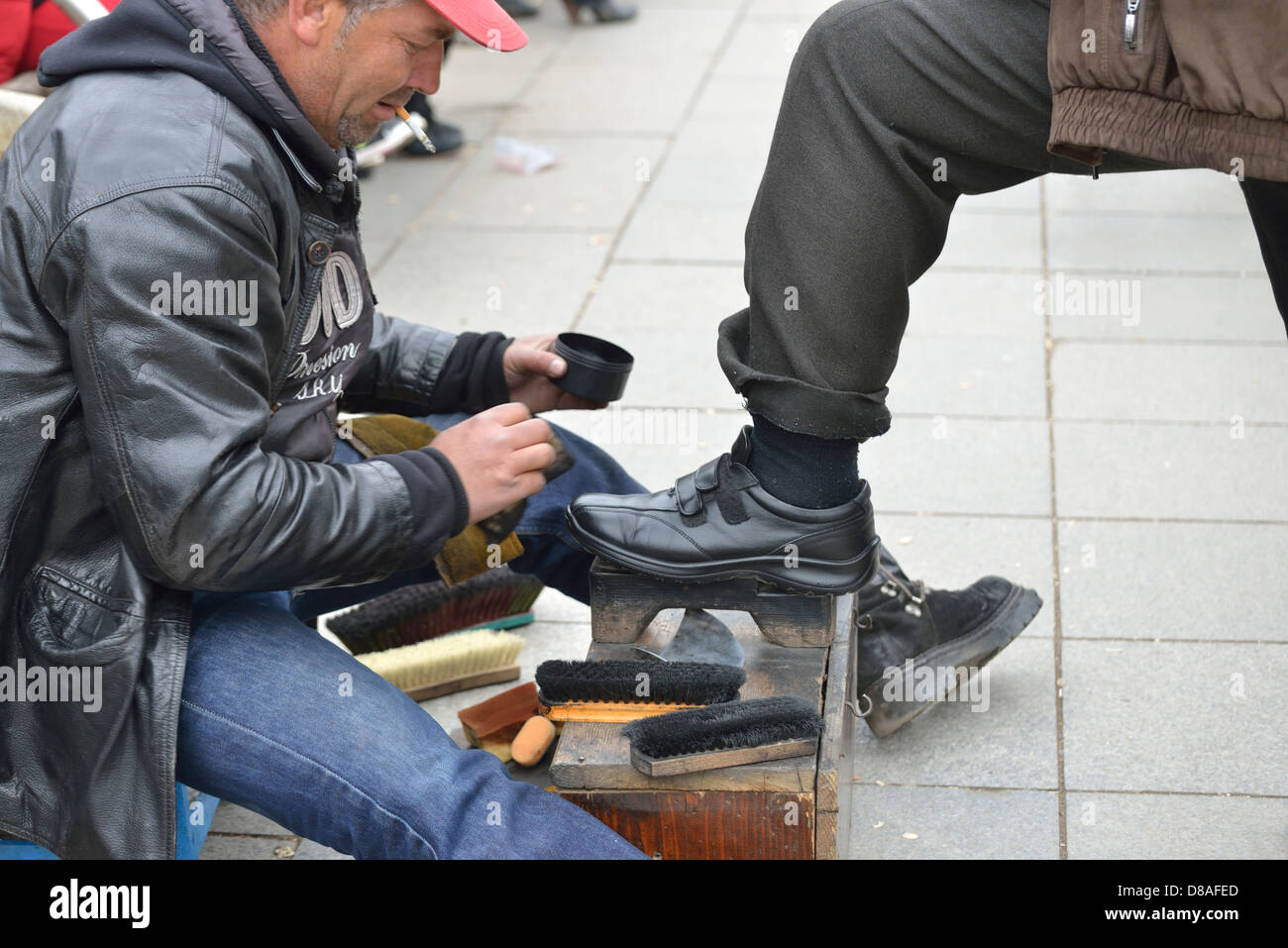 Shoe shiner in Mother Theresa Boulevard during 5th Independence Day