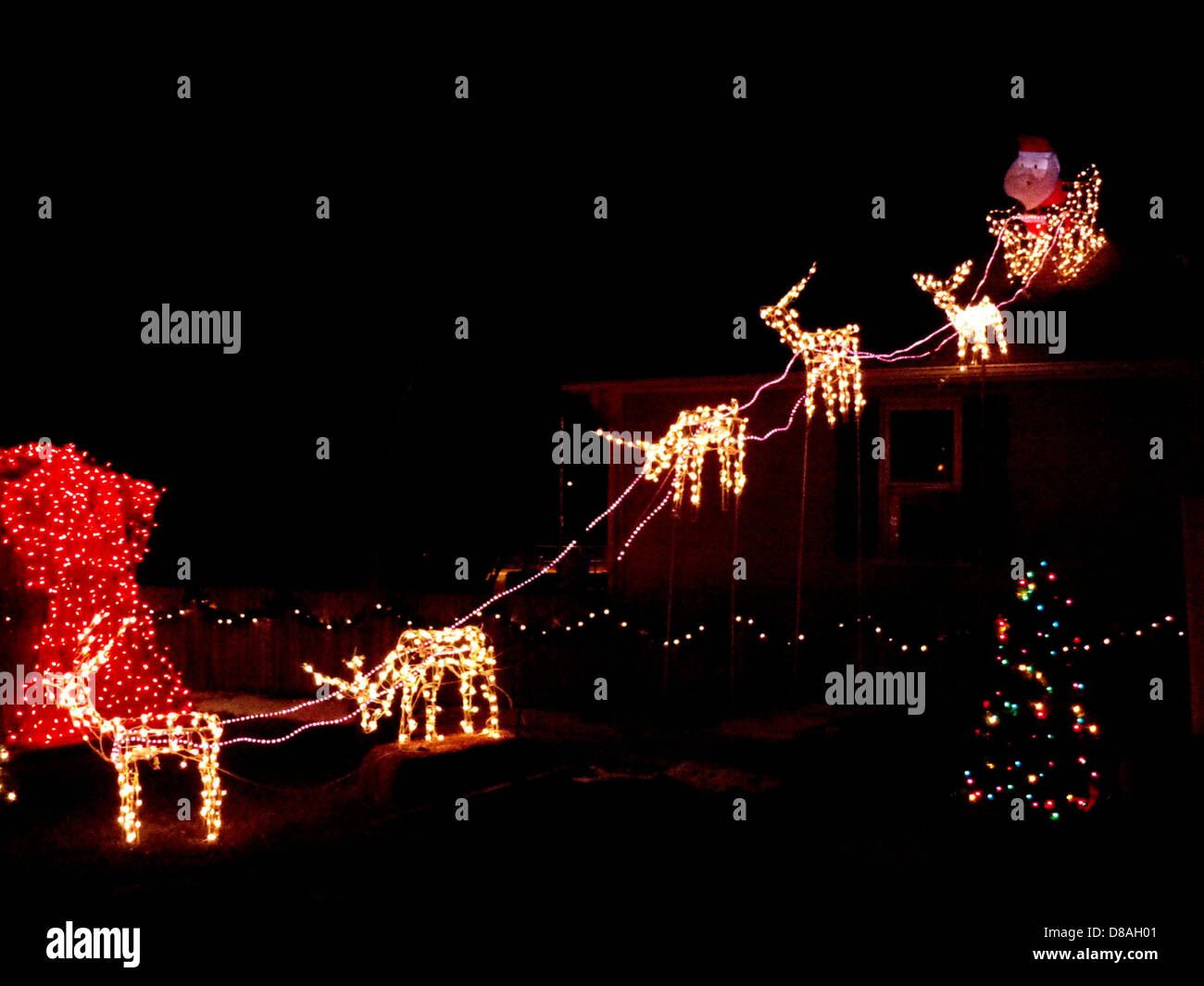 reindeer pulling santas sleigh holiday christmas lights Stock Photo - Alamy