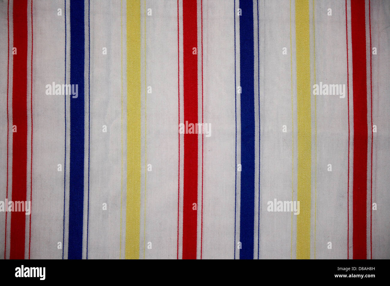 A close-up of a striped fabric featuring red, blue, and yellow patterns ...