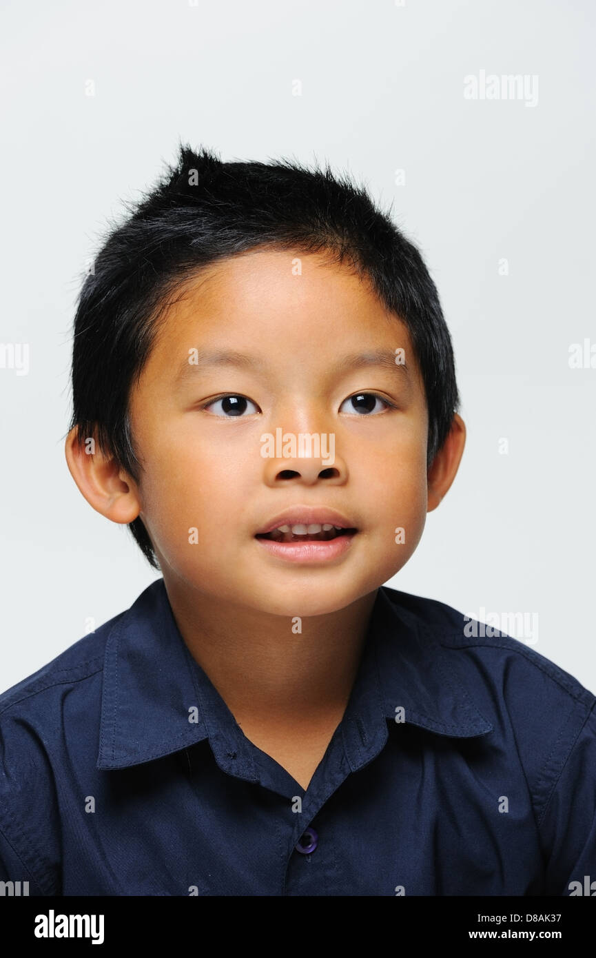 Asian boy smiling at camera wears blue shirt Stock Photo - Alamy