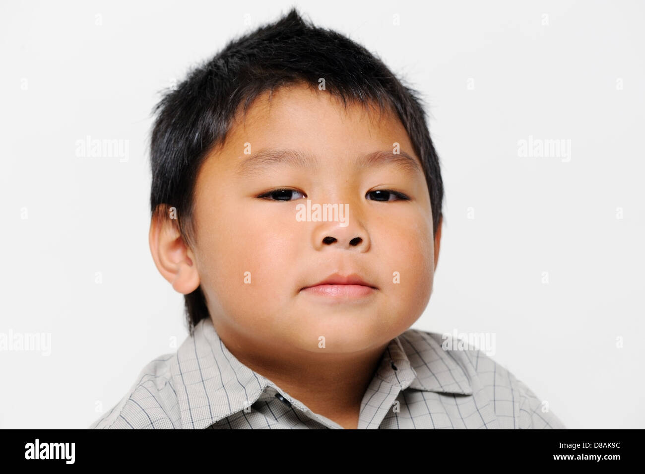Asian boy with chubby cheeks looks serious Stock Photo
