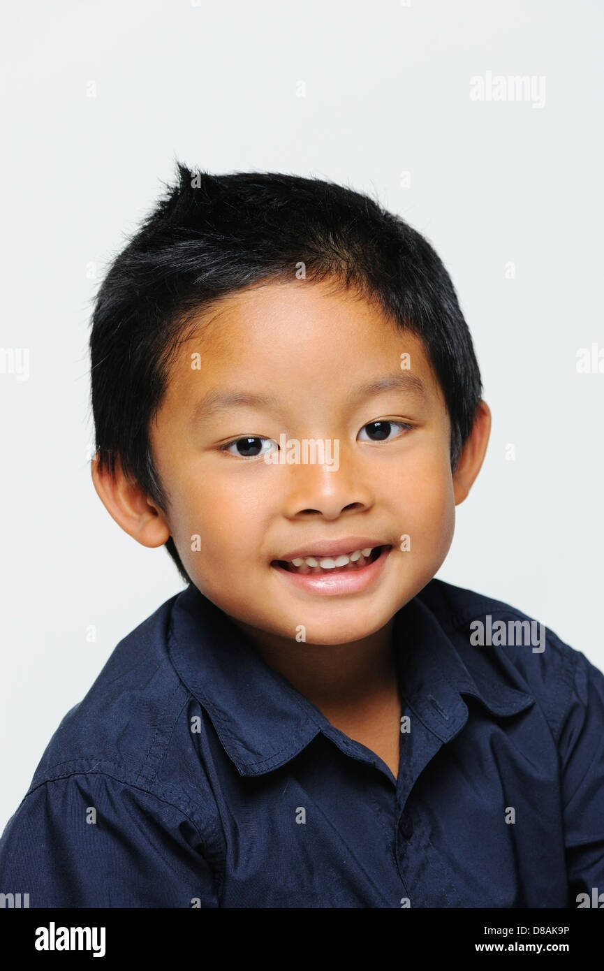Asian boy looking happy wearing blue shirt Stock Photo - Alamy