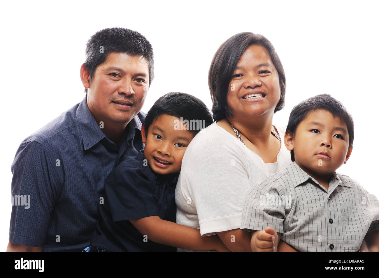 Asian family together looking happy and smiling in front of white isolated background Stock Photo