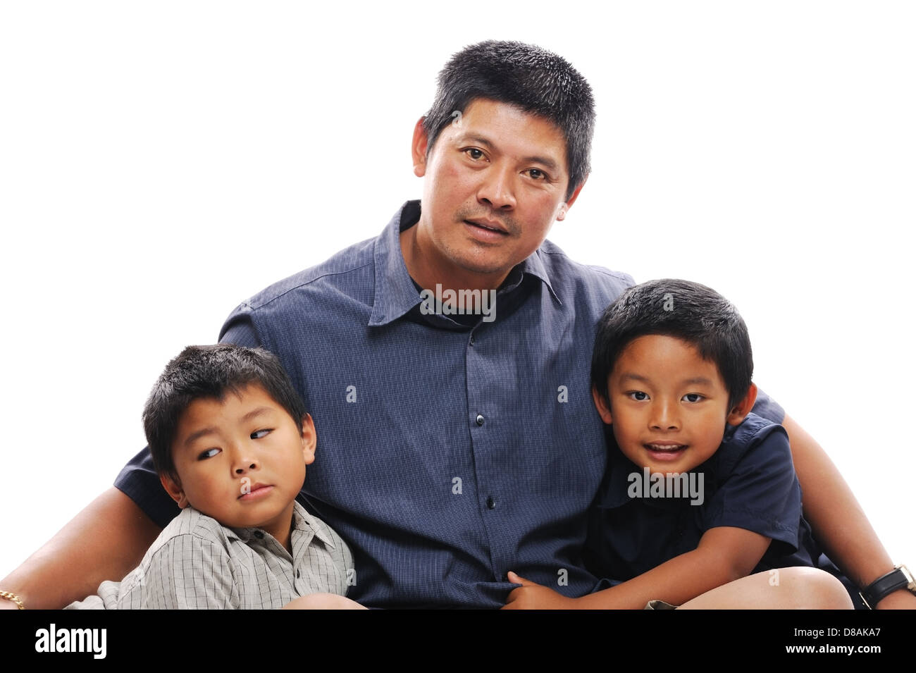 Asian father cuddles his two sons Stock Photo
