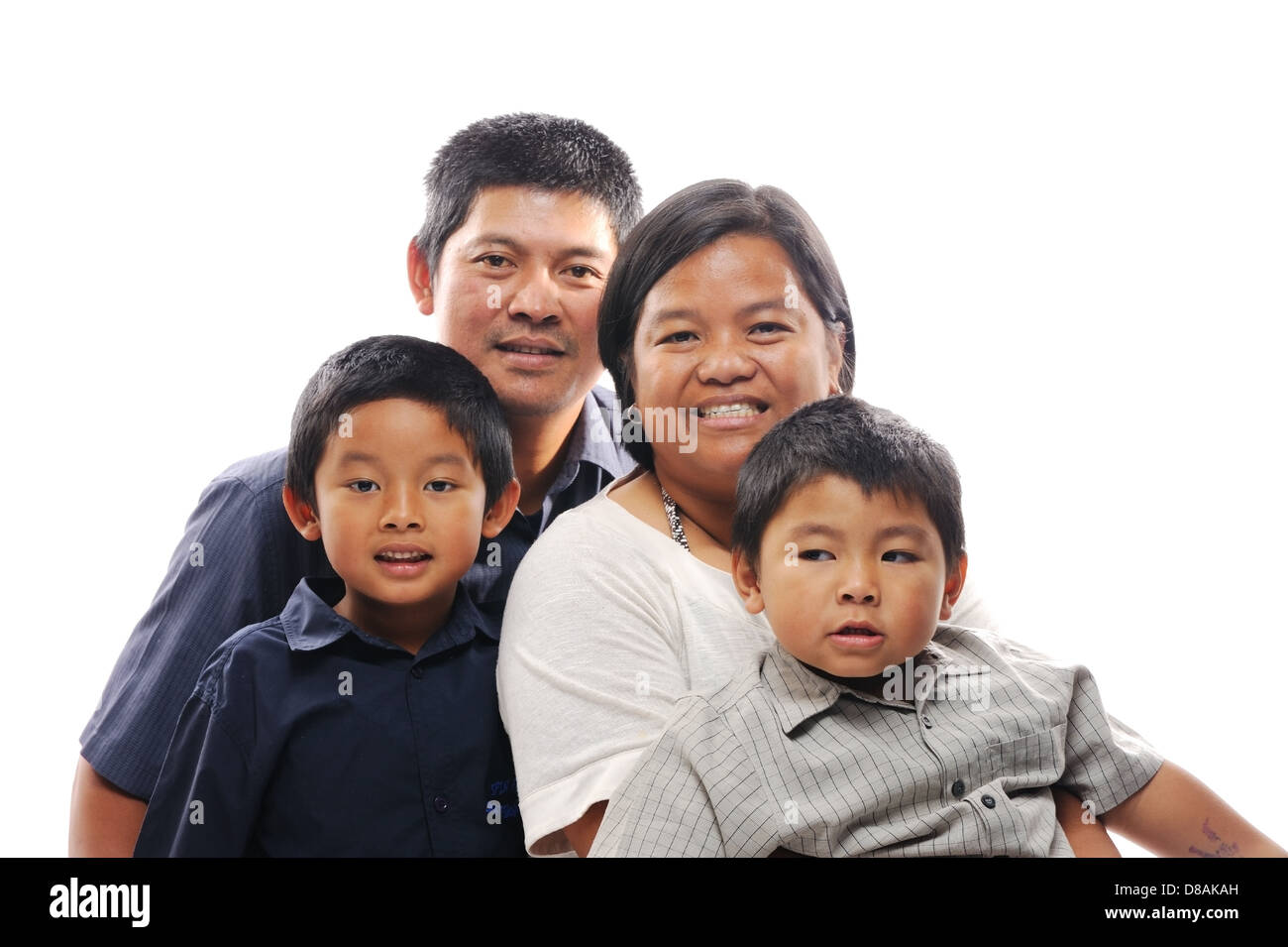 Happy filipino family together smiling in front of white isolated background Stock Photo